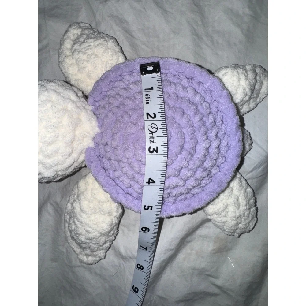 Hand crocheted‎ baby sea turtle white body and lilac purple shell.